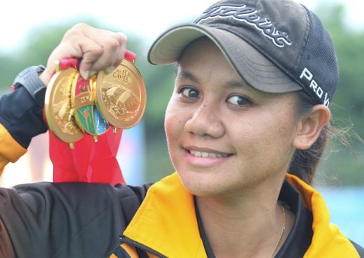 Archer Fatin Nurfatehah Mat Salleh with her gold medals at the 2015 Singapore Sea Games. Pix by Hairul Anuar Abd Rahim
