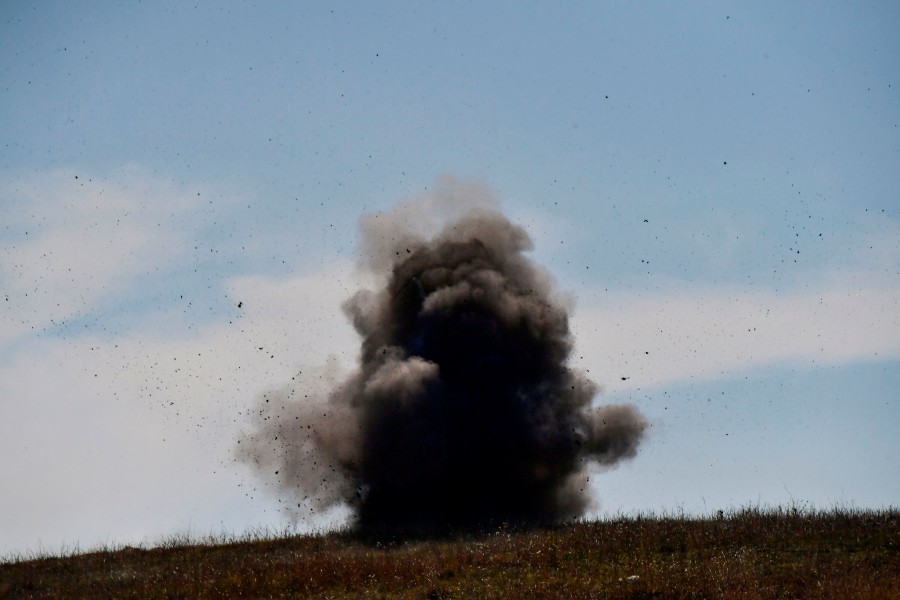A controlled explosion of collected unexploded cluster bombs by members of a sapper group of the Karabakh Ministry of Emergency Situations on the outskirts of Stepanakert on October 12, 2020, during the ongoing military conflict between Armenia and Azerbaijan over the breakaway region of Nagorno-Karabakh. - AFP pic