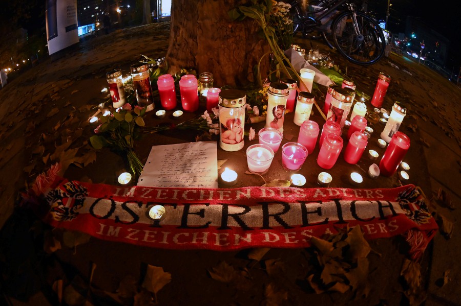 Flowers, candles and an Austria scarf are left at a memorial site at the scene of an attack in Vienna, Austria. - AFP pic