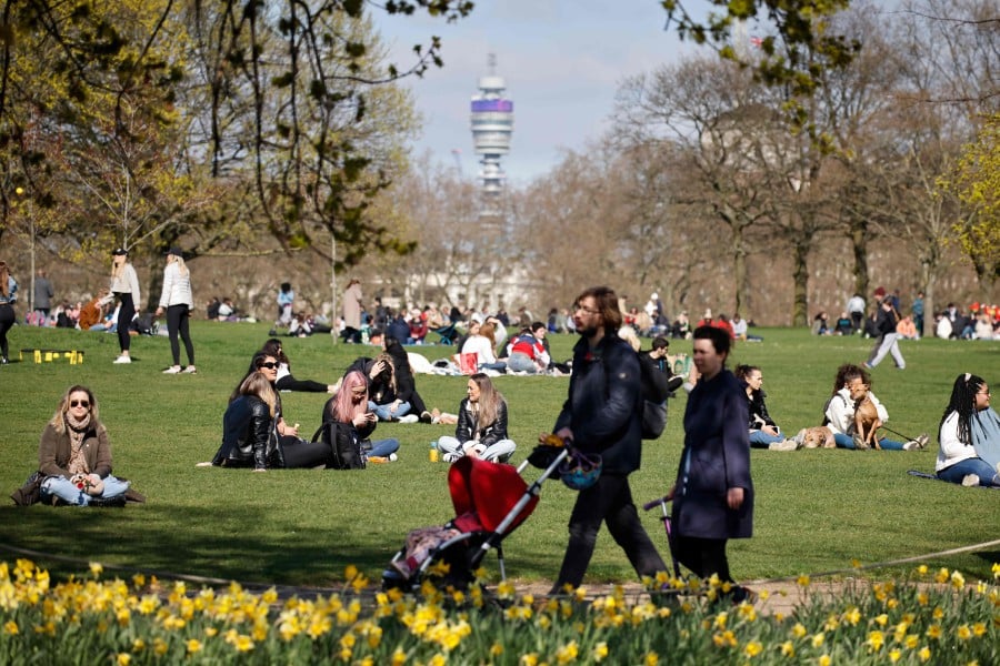 People relax in small groups in Hyde Park in central London on April 2,as life continues following an easing of the coronavirus restrictions to allow people from more than one household to meet outdoors. - AFP pic