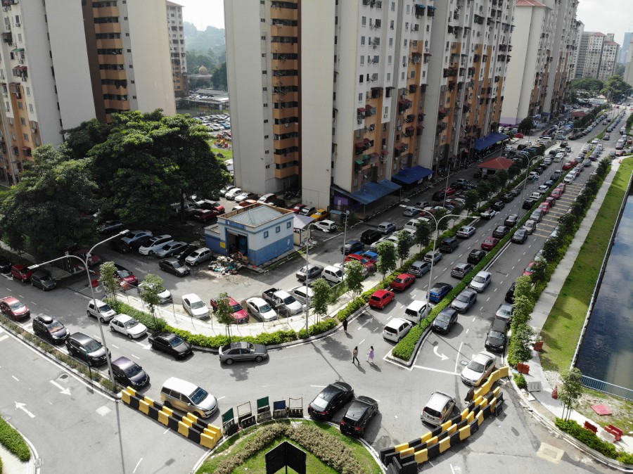 A view of cars parked along a road near a People’s Housing Projects (PPR) in Kuala Lumpur. - BERNAMA PIC