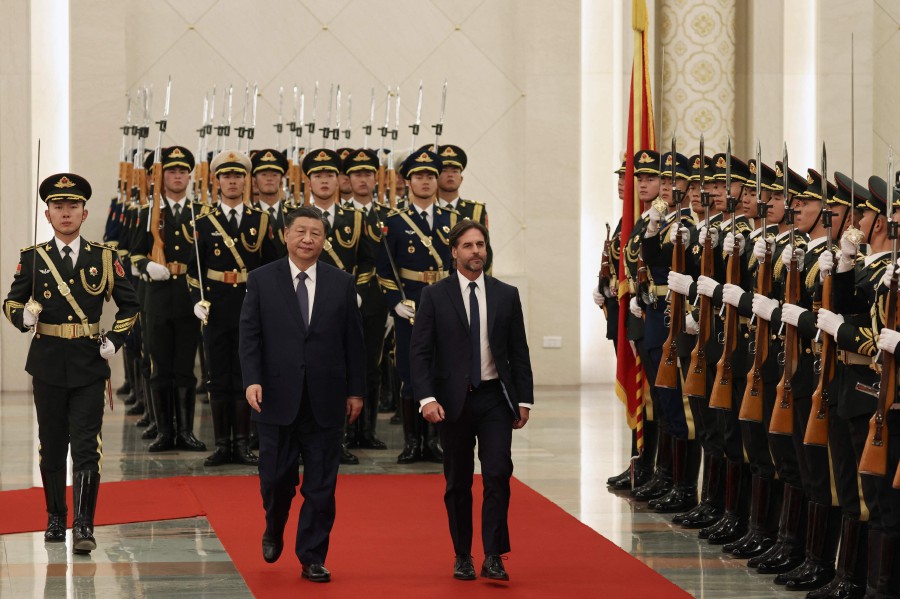 Uruguay President Luis Lacalle Pou (centre R) reviews a guard of honour with Chinese President Xi Jinping during a welcome ceremony at the Great Hall of the People in Beijing. - AFP PIC