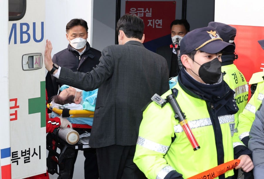 South Korean opposition party leader Lee Jae-myung, who was attacked in Busan, lies on a stretcher as he arrives at Seoul National University Hospital in Seoul. - AFP PIC