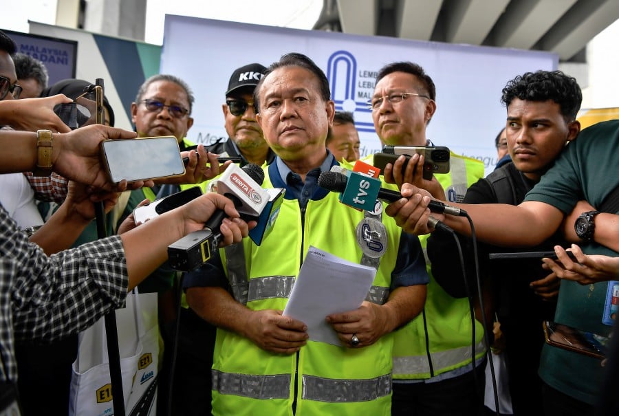 Datuk Seri Alexander Nanta Linggi speaking to reporters after launching the construction of additional motorcycle shelters at the New Pantai Expressway (NPE) in Kuala Lumpur. - BERNAMA PIC 