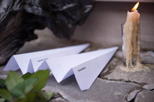Paper planes and a candle are placed in front of the Dutch embassy in Moscow on July 17, 2015 in memory of the people who died in the crash of Malaysian Airlines flight MH17. All 298 passengers and crew -- the majority Dutch -- died on July 17 last year when the Malaysia Airlines Boeing 777, on a flight between Amsterdam and Kuala Lumpur, was shot down over rebel-held east Ukraine during heavy fighting between Ukrainian forces and pro-Russian separatists. AFP PHOTO.