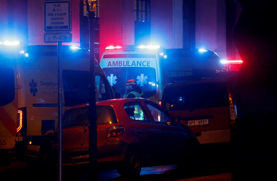 Medics stand next to ambulances parked near the area of the shooting at one of the buildings of Charles University in Prague, Czech Republic. - REUTERS PIC