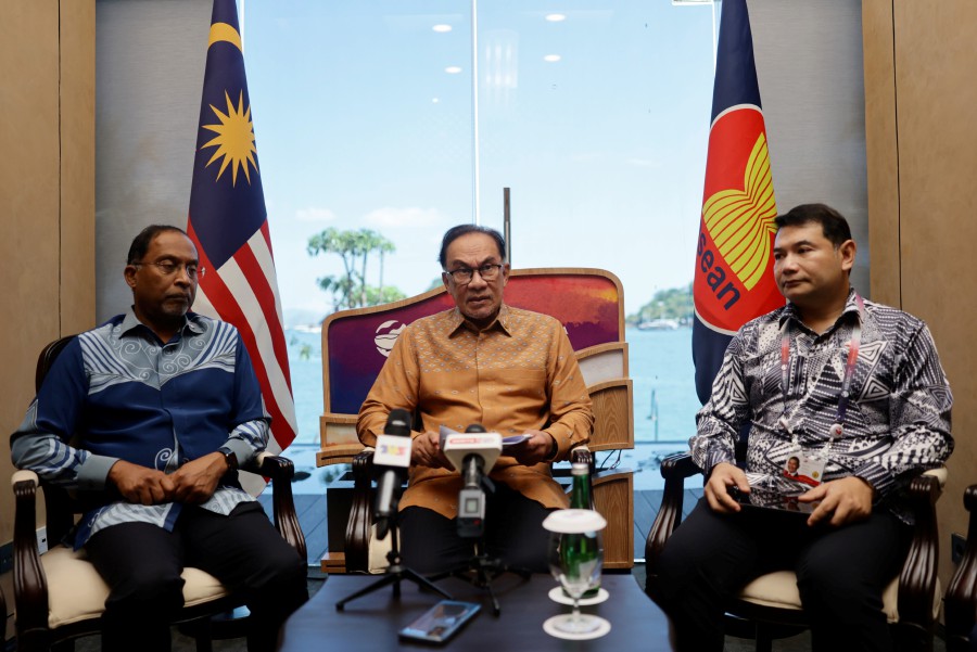 Prime Minister Datuk Seri Anwar Ibrahim speaks during a press conference in conjunction with the 2023 Asean Summit in Labuan Bajo, Indonesia. Also present are Foreign Minister Datuk Seri Zambry Abd Kadir (left) and Economy Minister Rafizi Ramli (right). - BERNAMA PIC