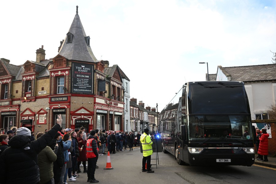 Fans react as the Manchester United team bus arrives ahead of the English Premier League football match between Liverpool and Manchester United at Anfield in Liverpool. - AFP PIC