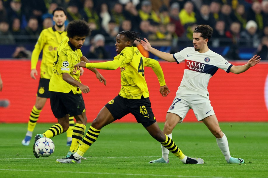 Borussia Dortmund's Jamie Bynoe-Gittens in action with Paris St Germain's Vitinha during the match at Signal Iduna Park, Dortmund. - REUTERS PIC