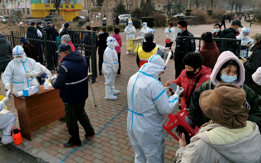 Residents line up at a nucleic acid testing site during a mass testing for the Covid-19, at a residential compound in Dalian, Liaoning province, China. - REUTERS PIC