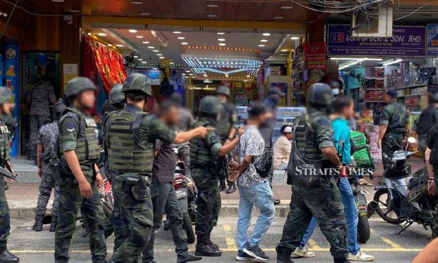 A file pic dated Dec 21, shows authorities arresting foreigners during a multi-enforcement-agency “Mini Dhaka” raid in Jalan Silang in Kuala Lumpur. - NSTP/Hafidzul Hilmi Mohd Noor