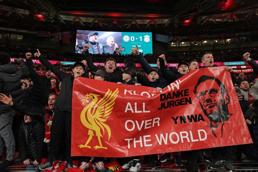 Liverpool fans celebrate following the English League Cup final football match between Chelsea and Liverpool at Wembley stadium, in London. - AFP PIC