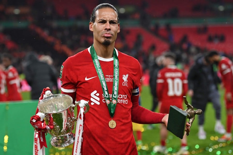 Liverpool's Dutch defender Virgil van Dijk poses with the trophy following the English League Cup final football match between Chelsea and Liverpool at Wembley stadium, in London. - AFP PIC