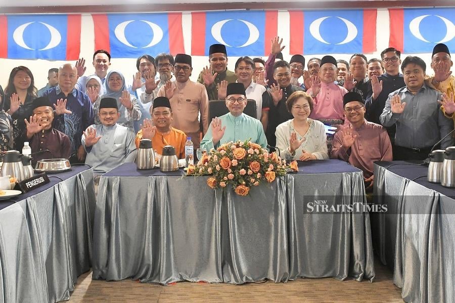 Prime Minister Datuk Seri Anwar Ibrahim (seated, centre) with Sabah PKR leader after a meeting in Kota Kinabalu. - NSTP/MOHD ADAM ARININ
