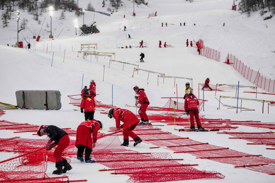 FIS and resort employees gather to dismantle the slope structures as the Men's Slalom event of the FIS Alpine Ski World Championship 2023 in Val d'Isere is cancelled due to snowfall and weather conditions. - AFP PIC