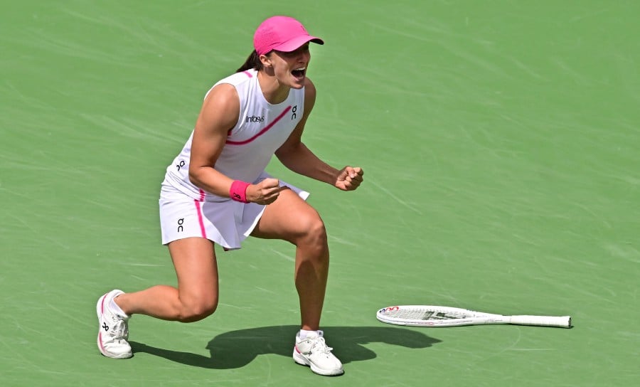  Poland's Iga Swiatek reacts after winning match point against Greece's Maria Sakkari during the ATP-WTA Indian Wells Masters women's final tennis match at the Indian Wells Tennis Garden in Indian Wells, California. - AFP PIC