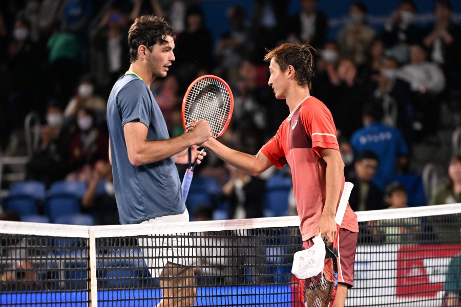 Japan's Shintaro Mochizuki (R) shakes hands with USA's Taylor Fritz after victory during their men’s singles match on day four of the ATP Japan Open tennis tournament in Tokyo. - AFP PIC