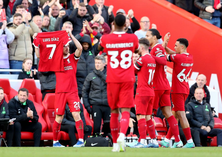 Liverpool's Diogo Jota is applauded by teammates while holding up a shirt in support of Luis Diaz as he celebrates scoring their first goal during the match against Nottingham Forest at Anfield, Liverpool. - REUTERS PIC
