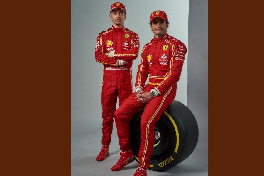 This handout photograph made available by Scuderia Ferrari, shows Ferrari's drivers for the 2024 season Charles Leclerc (L) and Carlos Sainz as the auto maker unveiled today the new single-seater SF-24 (F1) in its Italian home of Maranello. - (Photo by Handout / FERRARI PRESS OFFICE / AFP) 