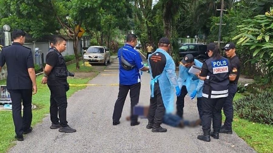 Police officers on the scene after a man died while walking towards his employer’s home in Petaling Jaya. - Pic courtesy of Police 