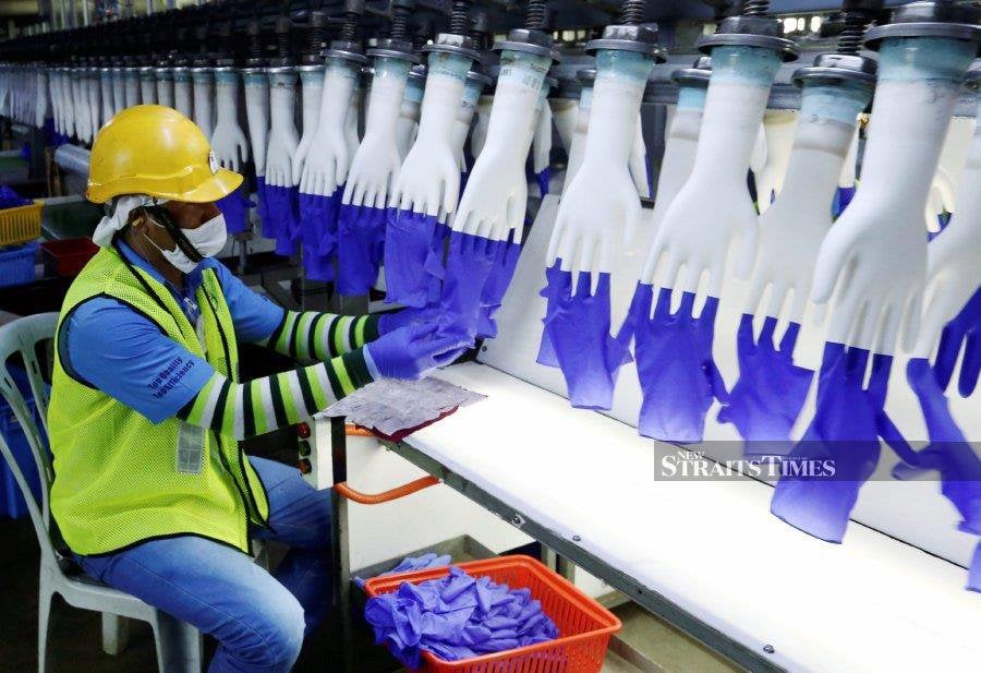 This file pic  dated Oct 10, 2016, shows a worker at the Top Glove Corp Bhd factory in Meru, Klang. - NSTP/File pic