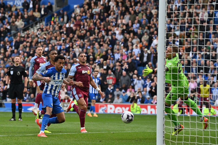 Brighton's Brazilian striker #09 Joao Pedro (4L) watches as his header beats Aston Villa's Swedish goalkeeper #25 Robin Olsen (R) after Olsen had saved his penalty during the English Premier League football match between Brighton and Hove Albion and Aston Villa at the American Express Community Stadium in Brighton, southern England on May 5, 2024. -- AFP