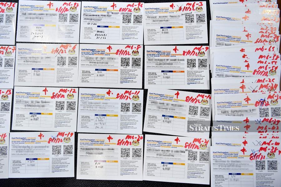 Fake vaccination certificates seized by police in Marang, shown during a press conference by police in Kuala Terengganu, on January 10, 2022.- BERNAMA PIC