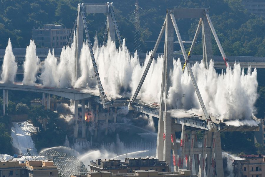 In this file photo taken on June 28, 2019 explosive charges blow up the eastern pylons of Genoa's Morandi motorway bridge in Genoa. - AFP FILE PIC