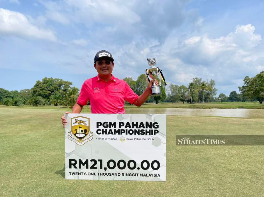 Nicholas Fung with the PGM Pahang Championship trophy at the Royal Pekan Golf Club yesterday.