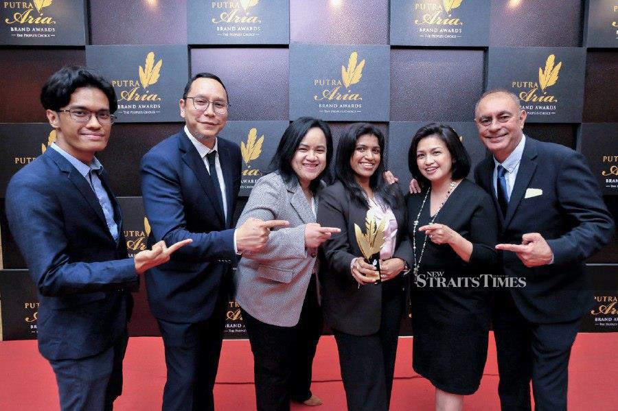 The New Straits Times team celebrate their award after the ceremony in Petaling Jaya. - NSTP/AIZUDDIN SAAD