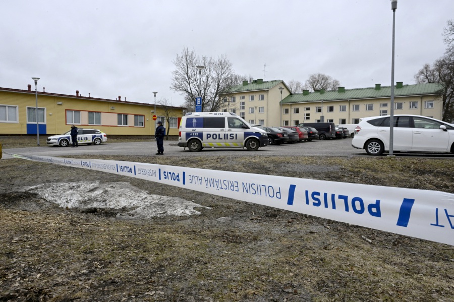 Police officers guard the scene behind police tapes at the Viertola comprehensive school in Vantaa, Finland, on April 2, 2024. Three minors were injured in a shooting at the school on Tuesday morning. A suspect, also a minor, has been apprehended. - Lehtikuva/MARKKU ULANDER via REUTERS 