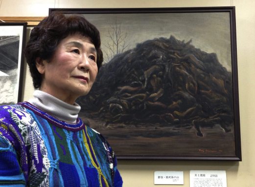  Haruyo Nihei speaks next to a painting depicting a pile of victims of Tokyo Firebombing at the Center of the Tokyo Raids and War Damage. Nihei was only 8-years-old when the biggest attack of the war, the firebombing of central Tokyo, killed over 100,000 people and left hundreds of thousands more homeless. She fled with her family and watched as many others were burned alive. As the flames swept over her, she was sheltered by her father and many others who piled on top of them who suffocated or burned to death. AP Photo 