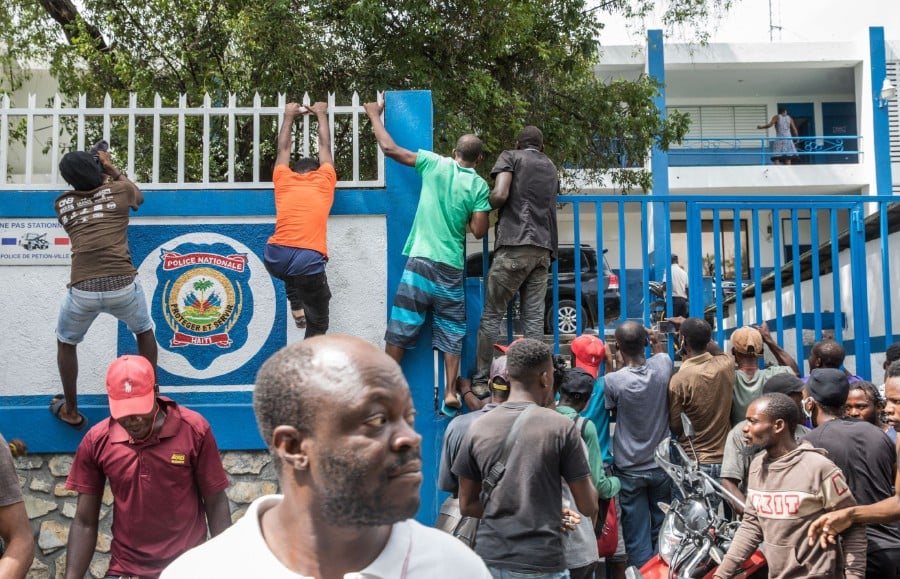 The crowd surrounds the Petionville Police station where armed men, accused of being involved in the assassination of President Jovenel Moise, are being held in Port au Prince on July 8. -AFP Pic