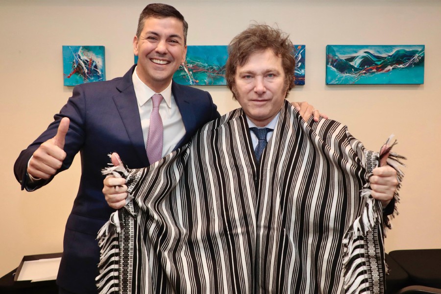Paraguay's President Santiago Peña (L) posing next to Argentina's President-elect Javier Milei after giving him a "Poncho Para'i de 60 Listas" as a present during a bilateral meeting in Buenos Aires. - AFP PIC