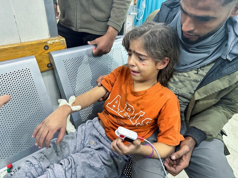 A Palestinian girl wounded in an Israeli strike on a house receives medical attention, after a temporary truce between Hamas and Israel expired, at Nasser hospital in Khan Younis in the southern Gaza Strip. - REUTERS PIC