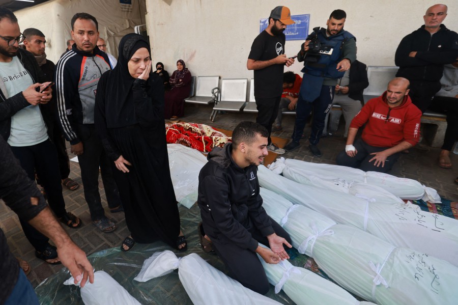 People gather to identify the bodies of family members killed in Israeli strikes on Rafah in the southern Gaza Strip, at the al-Najjar hospital. - AFP PIC