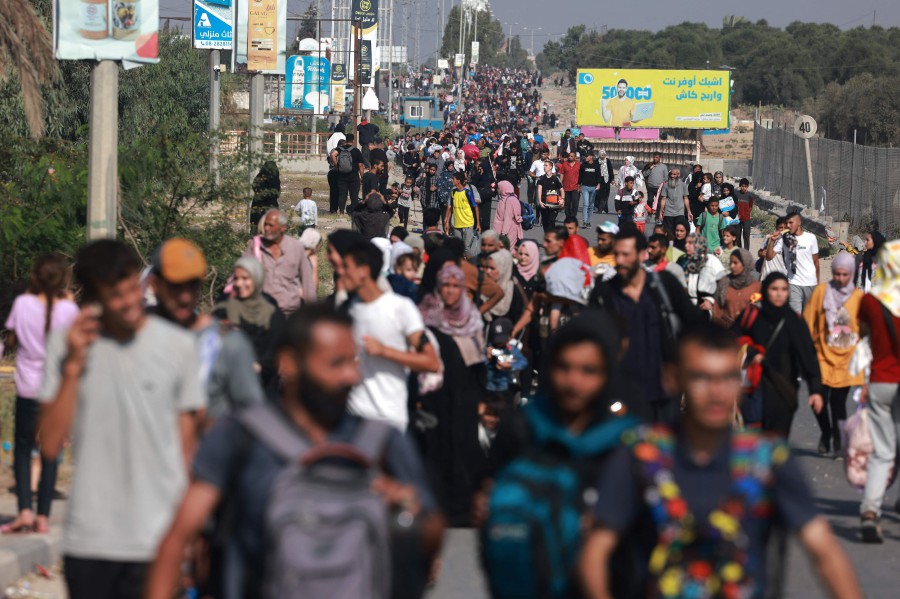  Palestinians fleeing Gaza City and other parts of northern Gaza towards the southern areas, walk on a road amid the ongoing battles between Israel and Hamas. - AFP PIC