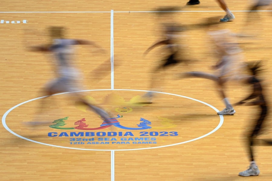 A general view shows players for Thailand (in white) and Malaysia (in black) competing in their women's basketball group stage match at the SEA Games (Southeast Asian Games) in Phnom Penh.-AFP PIC 