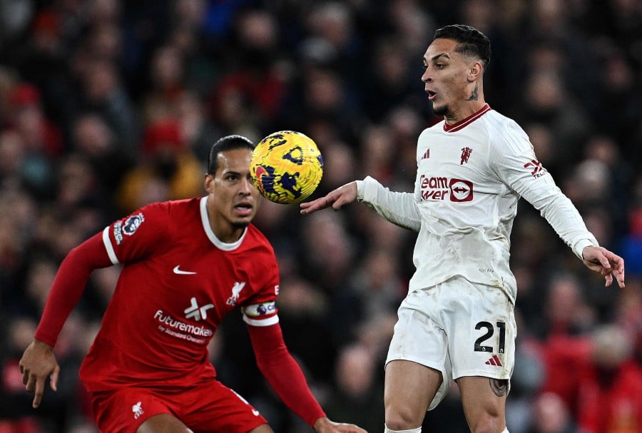 Liverpool's Virgil van Dijk (L) vies with Manchester United's Antony during the English Premier League football match between Liverpool and Manchester United at Anfield in Liverpool. - AFP PIC