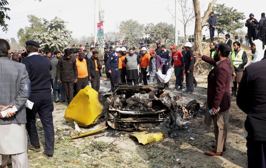 e Pakistani security officials inspect the scene of a bomb blast in Islamabad, Pakistan. - EPA PIC