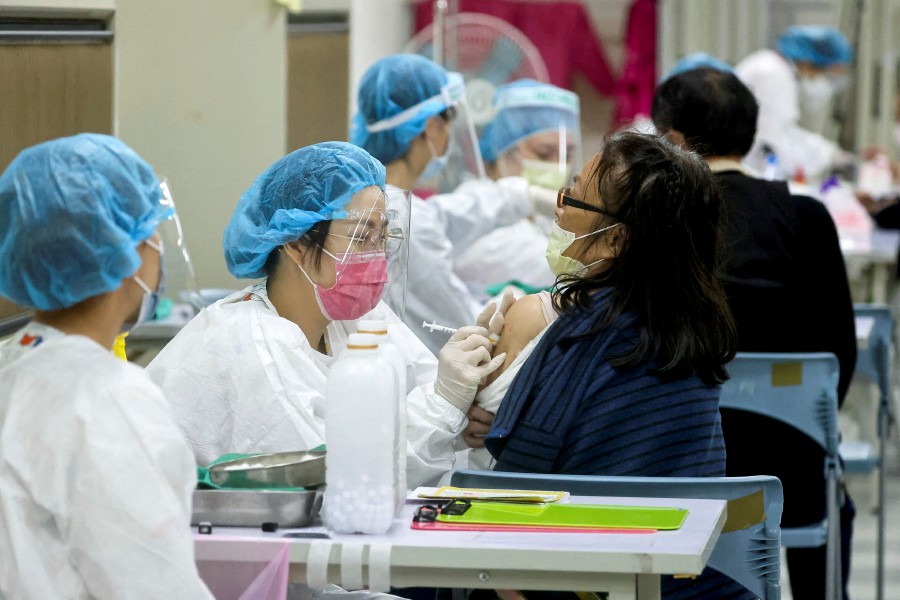 A woman receives a Covid-19 booster shot at a community centre, in Taipei, Taiwan. - REUTERS FILE PIC
