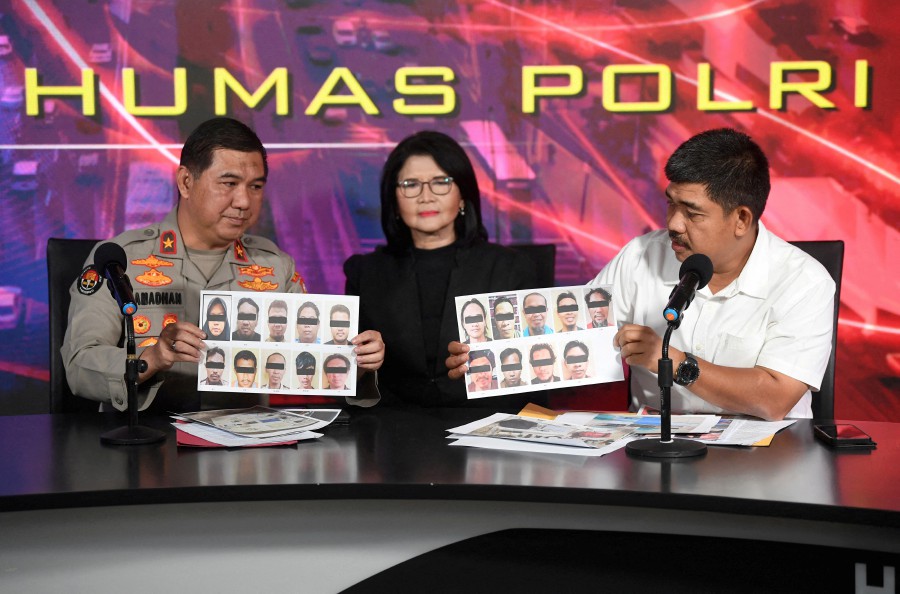 Spokesperson for Indonesia's Densus 88 counter-terrorism task force Aswin Siregar (R) and Indonesian Police Brigadier General Ahmad Ramadhan (L) show the photos of suspected militants arrested in October 2023, during a press conference in Jakarta, Indonesia. - REUTERS PIC