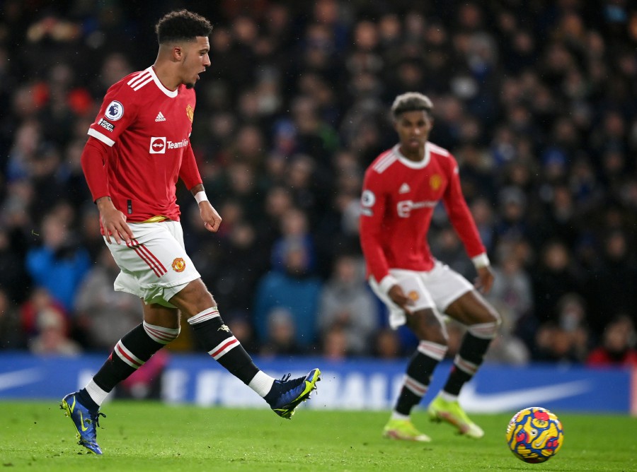  Manchester United's Jadon Sancho (L) scores the first goal against Chelsea in London. - EPA PIC