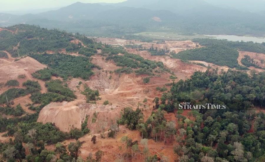 This file pic dated June 15, shows the deforestation and mining activities taking place at Bukit Kampung Melai, Tasik Chini. -NSTP/FARIZUL HAFIZ AWANG