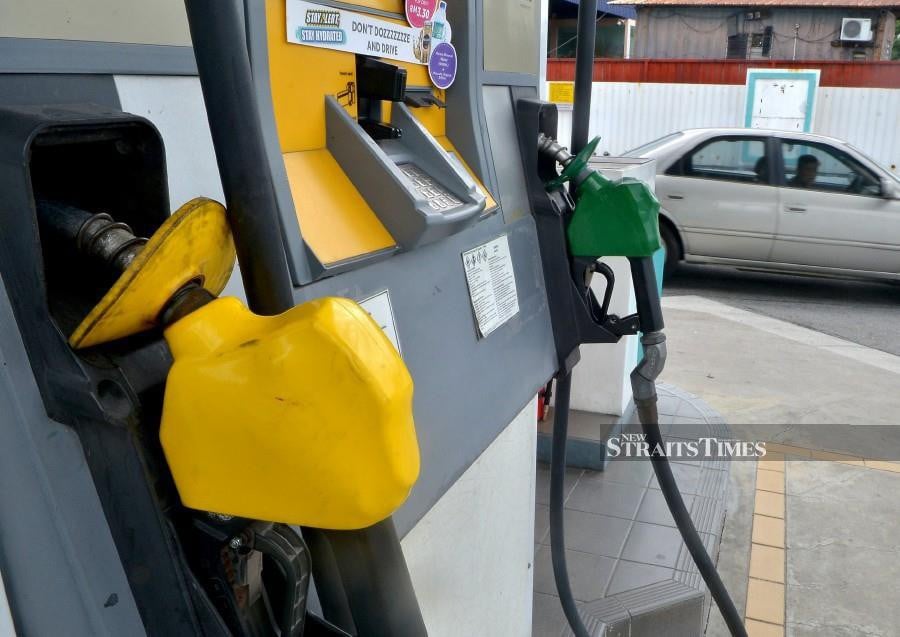 Vehicle owners who fill up their tanks with RON95 and RON97 petrol will enjoy cheaper fuel throughout the coming week, starting from midnight. - NST/file pic