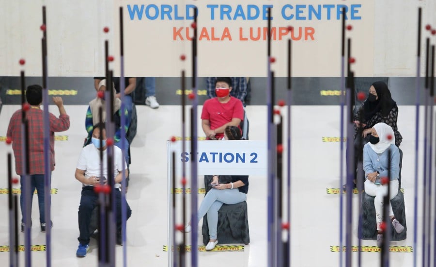 Members of the public waiting for their turn to be inoculated at the World Trade Centre Kuala Lumpur vaccination centre (PPV). -NSTP/MOHAMAD SHAHRIL BADRI SAALI