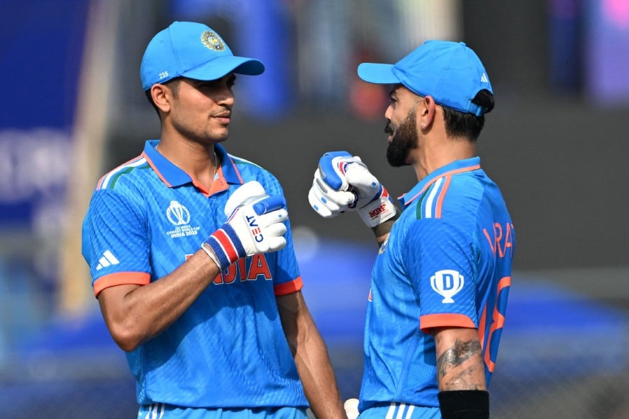India's Virat Kohli (R) gestures to teammate Shubman Gill during the 2023 ICC Men's Cricket World Cup one-day international (ODI) first semi-final match between India and New Zealand at the Wankhede Stadium in Mumbai. -AFP PIC