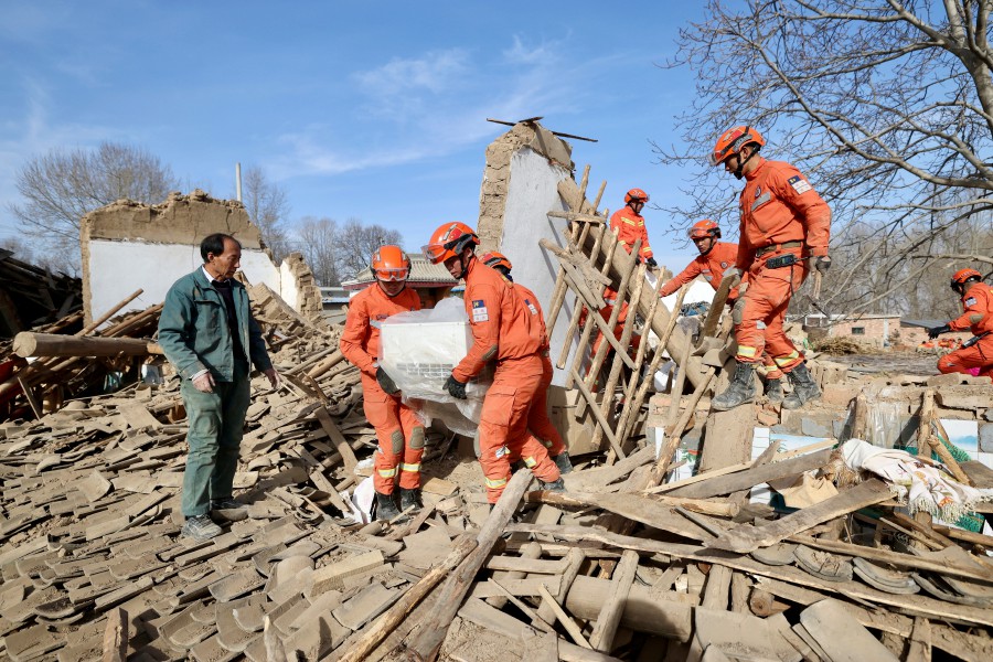 Rescuers work amid the rubble at Shiyuan village following the earthquake in Jishishan county, Gansu province, China. - REUTERS PIC