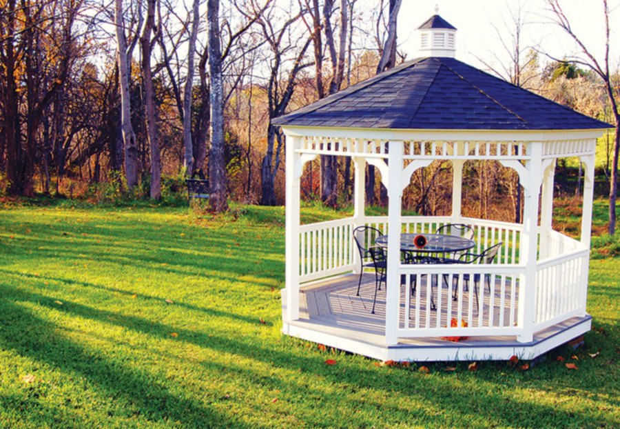 A small wooden gazebo with a barbecue pit for nice gatherings in the outdoors.