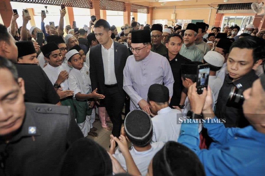 Prime Minister Datuk Seri Anwar Ibrahim mingles with the congregation after performing Friday prayers at the Al Hijrah Mosque in Desa Pinggiran Putra, Kajang. -NSTP/AIZUDDIN SAAD